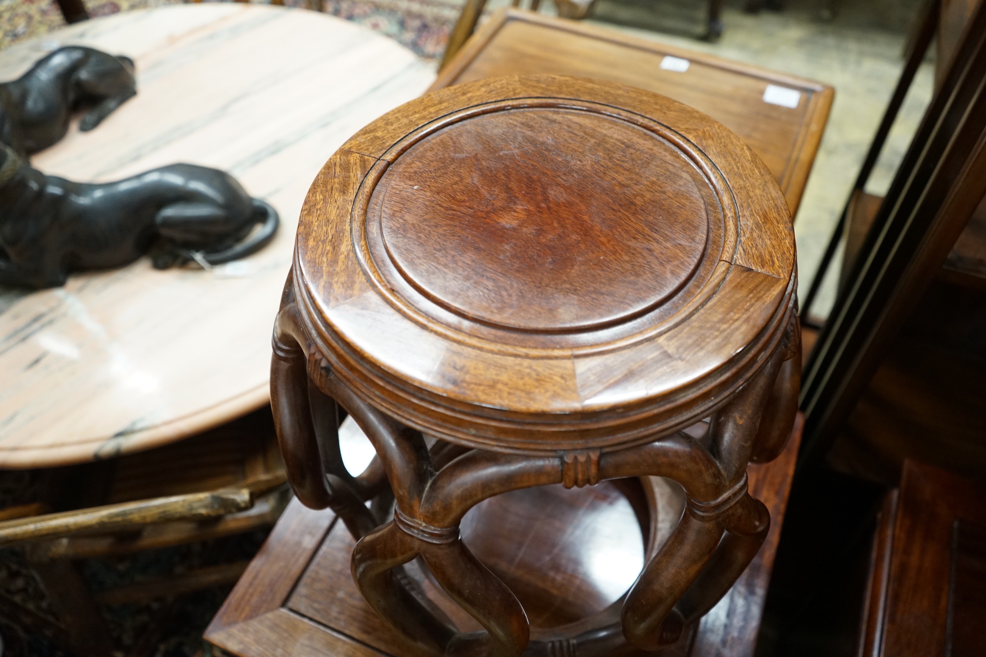 A pair of Chinese padouk wood jardiniere stands, diameter 38cm, height 46cm